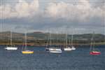 Yachts in Millport Bay with Farland Point and West Kilbride wind farm