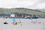 Coal carrier Norpol in Largs Channel with sailing dinghies from SportScotland National Centre Cumbrae