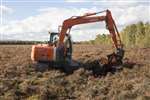 Digger depositing peat, Wester Moss, Fallin