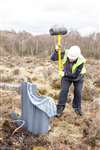 Bog Squad hammering in a plastic dam, Wester Moss